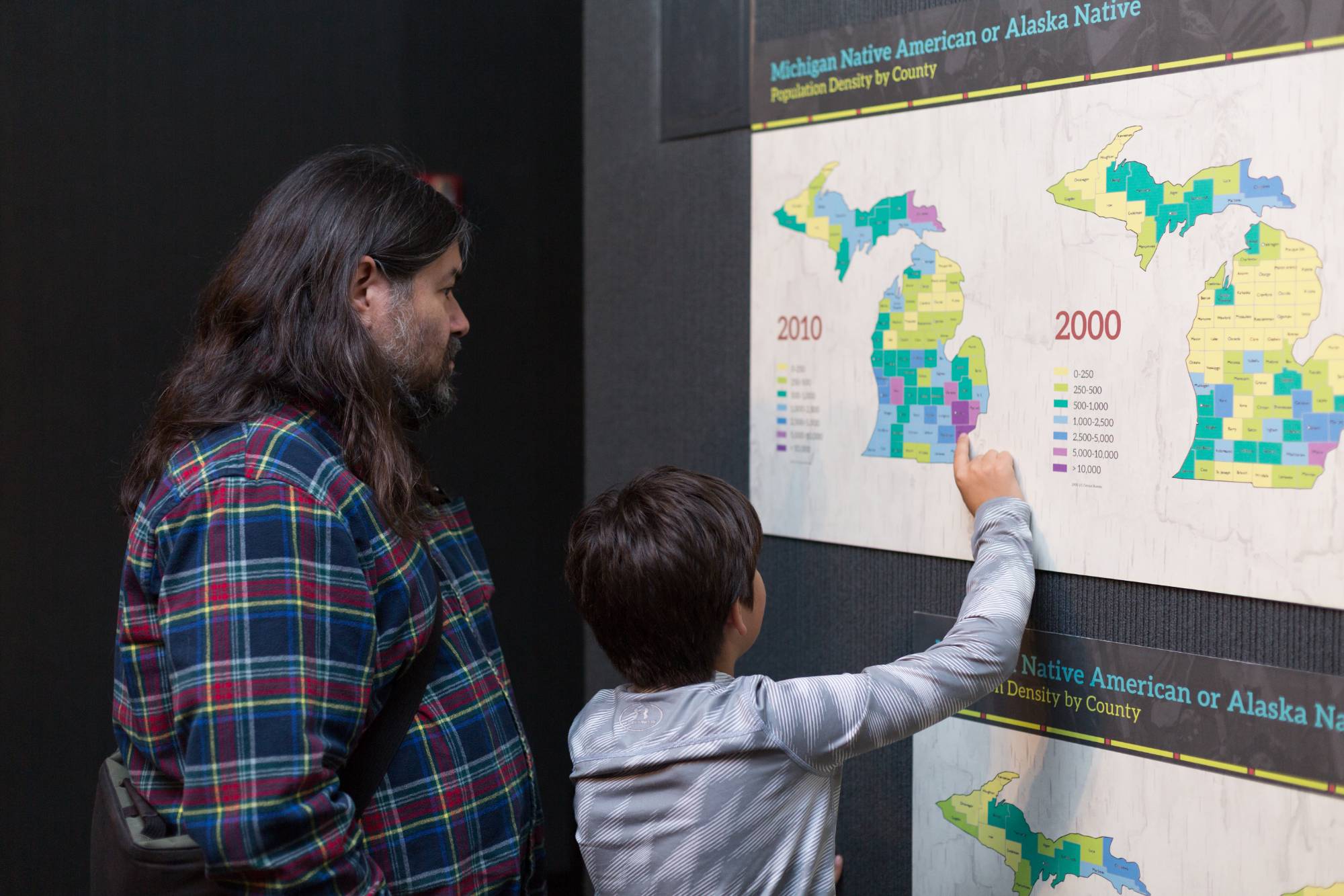 Child pointing to a map of Indigenous people in Michigan today